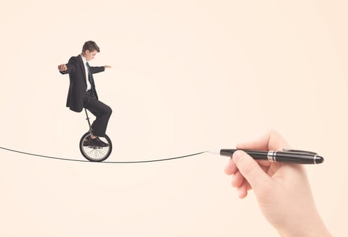 Businessman riding monocycle on a rope drawn by hand concept